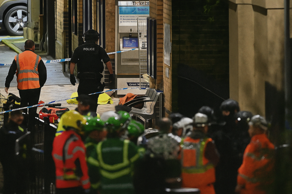 British Transport Police officers standing on a Cambridgeshire train platform after the stabbing incident.