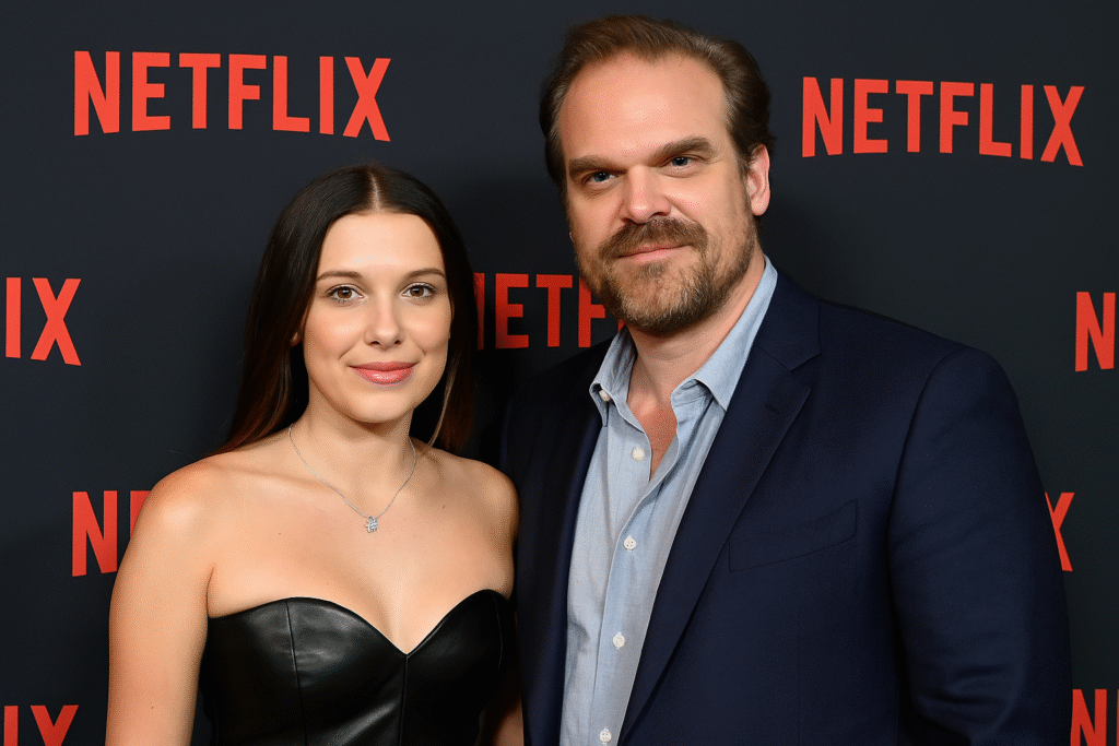 Millie Bobby Brown and David Harbour posing together at an earlier Netflix event.