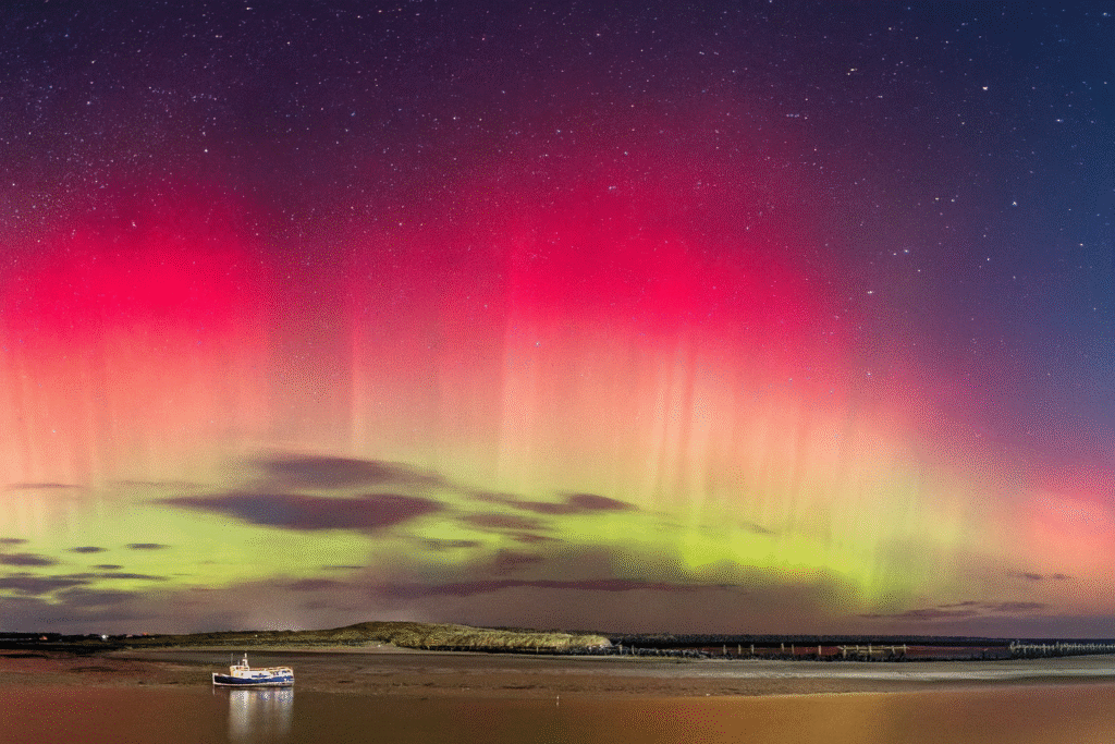 Vibrant green and purple northern lights illuminating the night sky over the continental United States.