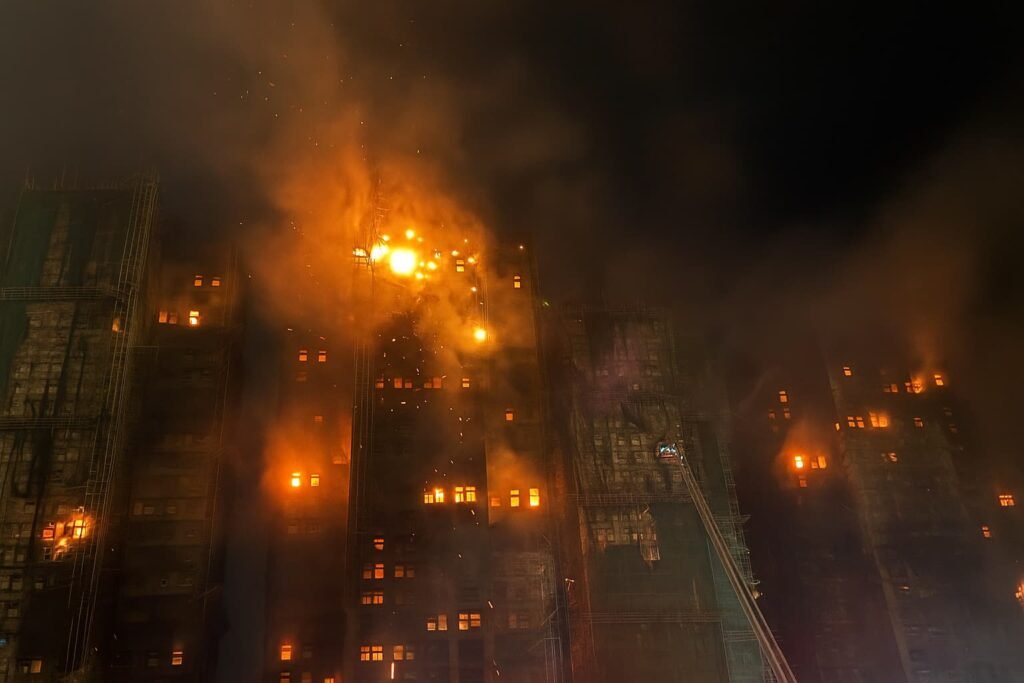 Flames engulf multiple towers at Wang Fuk Court in Hong Kong as smoke billows from the high-rise complex during the 2025 disaster.