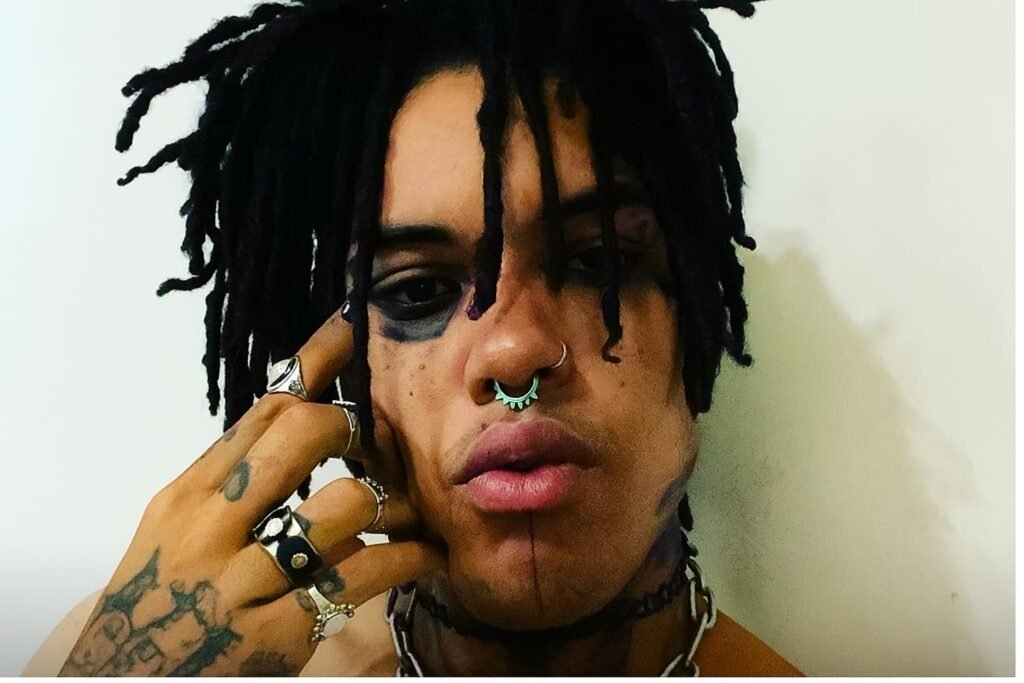 POORSTACY posing in a studio-style photo with signature emo-punk styling.