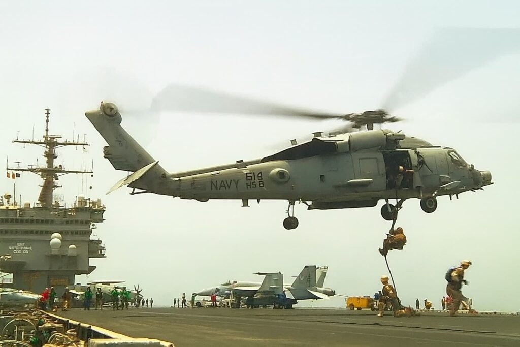 US Coast Guard personnel rappelling onto the seized Venezuelan oil tanker during an interdiction operation.