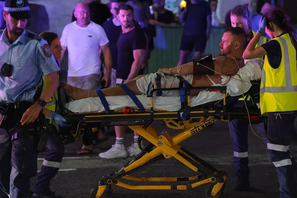 Emergency responders assist injured victims after Bondi Beach shooting.