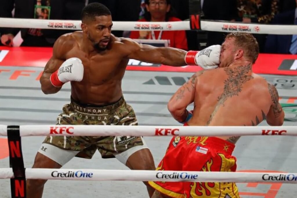 Jake Paul and Anthony Joshua exchanging punches in the ring.
