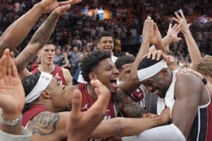 Bam Adebayo celebrating with Miami Heat teammates after scoring 83 points against the Washington Wizards