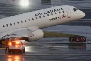 Damaged Air Canada Express regional jet at LaGuardia Airport after colliding with a Port Authority fire truck on Runway 4 late Sunday killing pilots Antoine Forest and Mackenzie Gunther