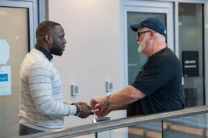 Tyler Perry greeting TSA workers at Hartsfield-Jackson Atlanta International Airport after distributing $1,000 Visa gift cards to officers working six weeks without reliable pay during the DHS government shutdown in March 2026
