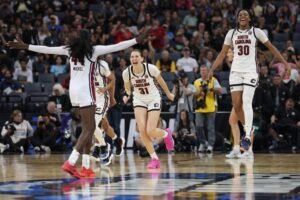 South Carolina Gamecocks celebrating their Elite Eight victory as the undefeated 35-0 Gamecocks advance to the Final Four seeking to become the first team to finish a season at 37-0 in NCAA women's basketball history