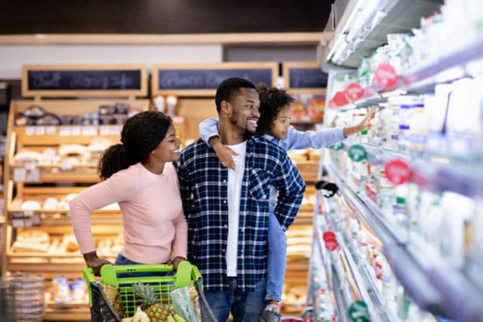 American family at grocery store facing higher prices as March 2026 CPI shows food and energy inflation accelerating due to Iran war