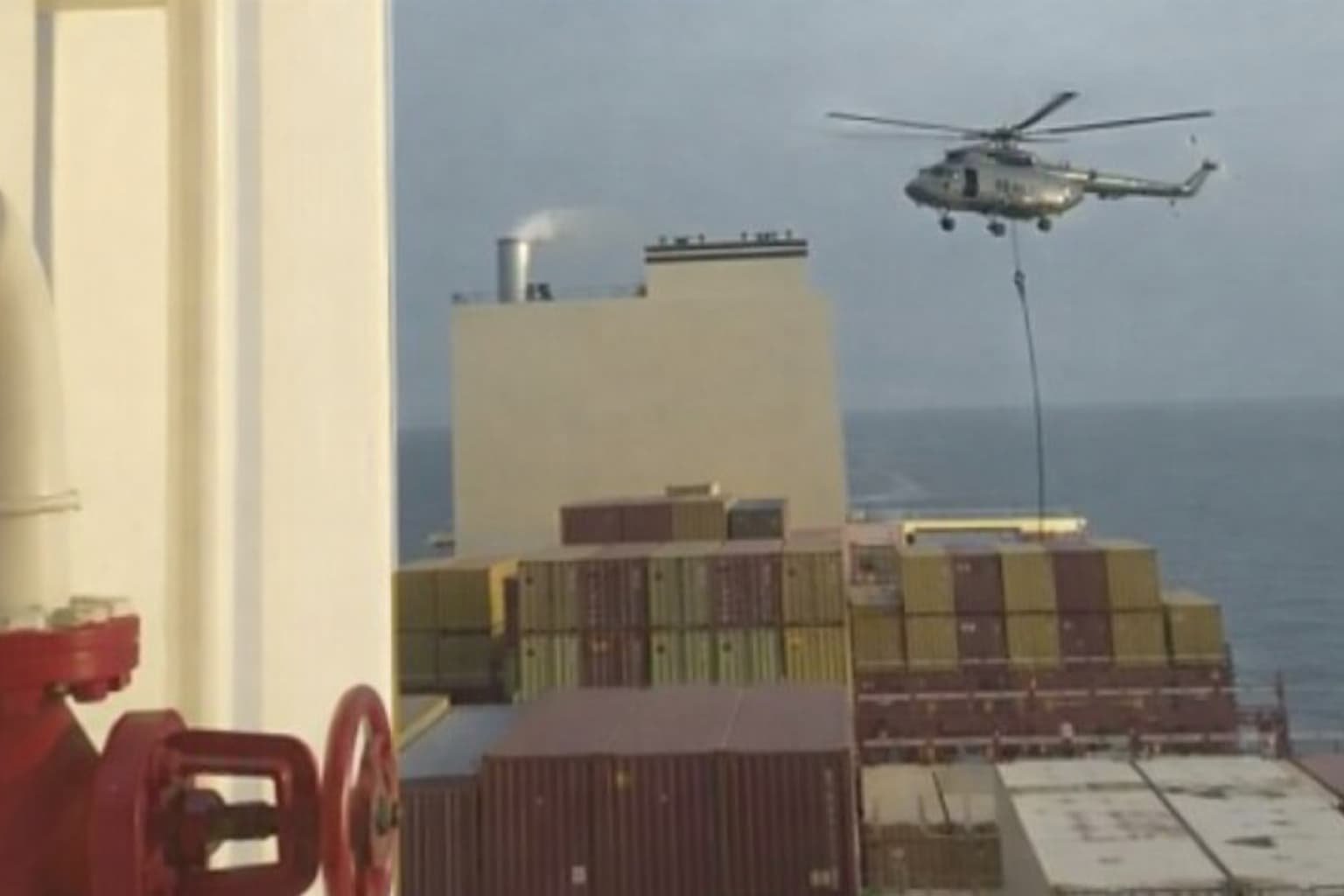 US Marines rappelling from helicopter onto Iranian flagged cargo ship Touska seized during blockade April 2026