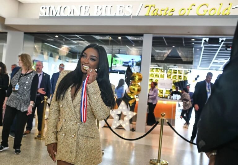 Simone Biles smiling at grand opening of Taste of Gold restaurant in Terminal A of George Bush Intercontinental Airport Houston Texas as gymnastics GOAT launches food venture May 2026