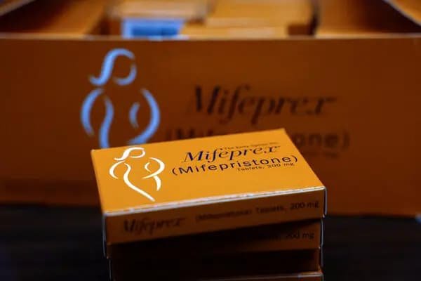 Boxes of mifepristone abortion pill medication at a pharmacy representing telehealth prescription access ruling
