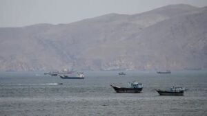 US Navy warship firing at Iranian fast attack boats in Strait of Hormuz during Project Freedom commercial ship escort operation as first direct military exchange since ceasefire occurs May 4 2026
