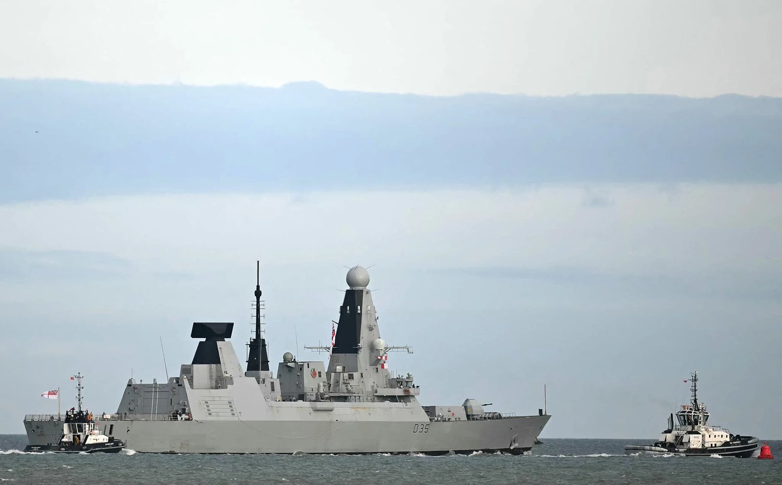 Royal Navy warship HMS Dragon departing Portsmouth England for Middle East pre-positioning as UK joins France in leading 40-nation coalition to protect shipping when Strait of Hormuz reopens May 2026