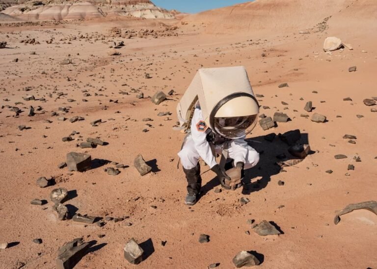 Mars surface landscape with astronaut conducting geological sampling during proposed 30-day surface stay in 153-day round trip mission made possible by 2031 asteroid orbital window