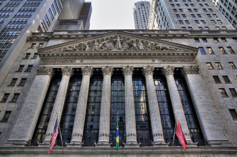 New York Stock Exchange trading floor as S&P 500 closes at record high of 7,398.93 for sixth consecutive weekly gain driven by AI earnings while consumer sentiment hits historic low of 48.2 May 8 2026