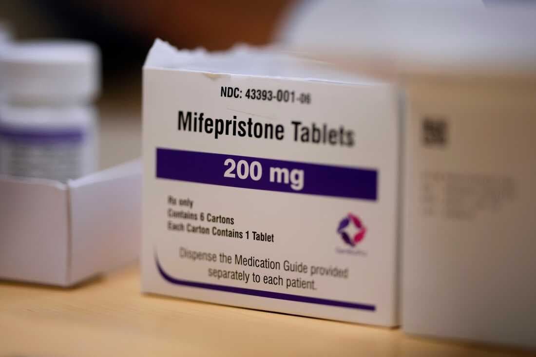 Mifepristone medication abortion pill pack on medical desk as Fifth Circuit Court of Appeals blocks nationwide mailing of drug used in 63 percent of US abortions May 2026