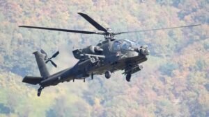 US Army AH-64 Apache attack helicopter in flight over Persian Gulf region representing aircraft that went down near Strait of Hormuz on June 8 2026 with both crew rescued by Navy surface drone