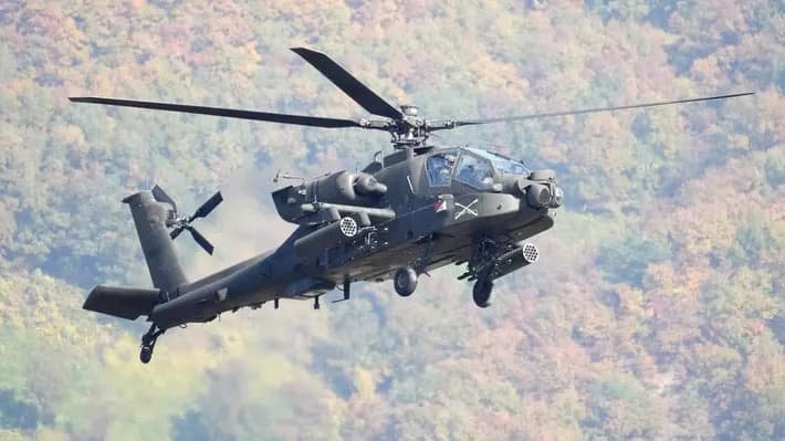 US Army AH-64 Apache attack helicopter in flight over Persian Gulf region representing aircraft that went down near Strait of Hormuz on June 8 2026 with both crew rescued by Navy surface drone