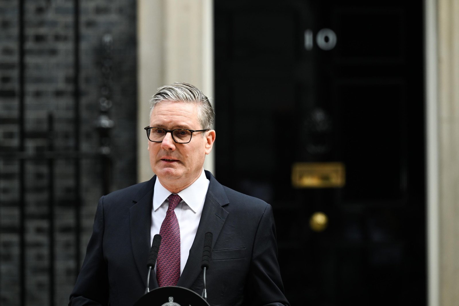 UK Prime Minister Keir Starmer delivering resignation statement outside 10 Downing Street in London on June 22 2026 flanked by wife Victoria Starmer