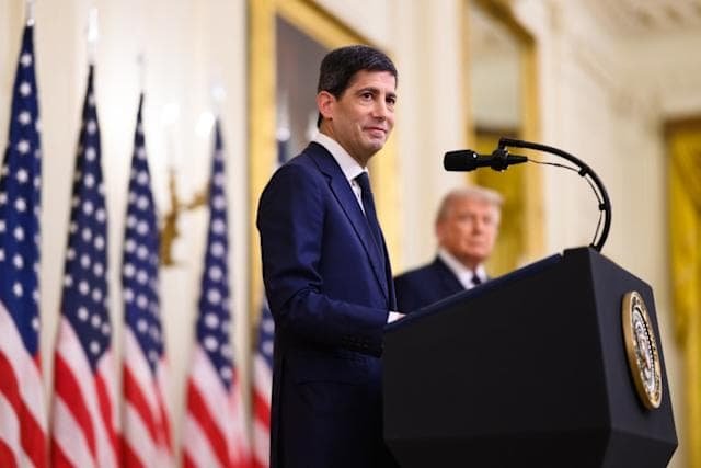 Kevin Warsh at Federal Reserve podium representing first press conference as Fed chair after June 16-17 FOMC meeting where J.P. Morgan predicts explicit shift away from easing bias to neutral stance
