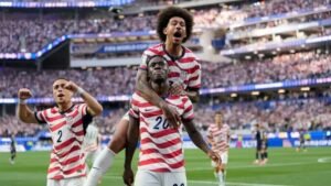 Folarin Balogun celebrating with USMNT teammates after scoring for the United States in their 3-0 opening FIFA World Cup 2026 victory over Paraguay at SoFi Stadium Los Angeles June 12 2026